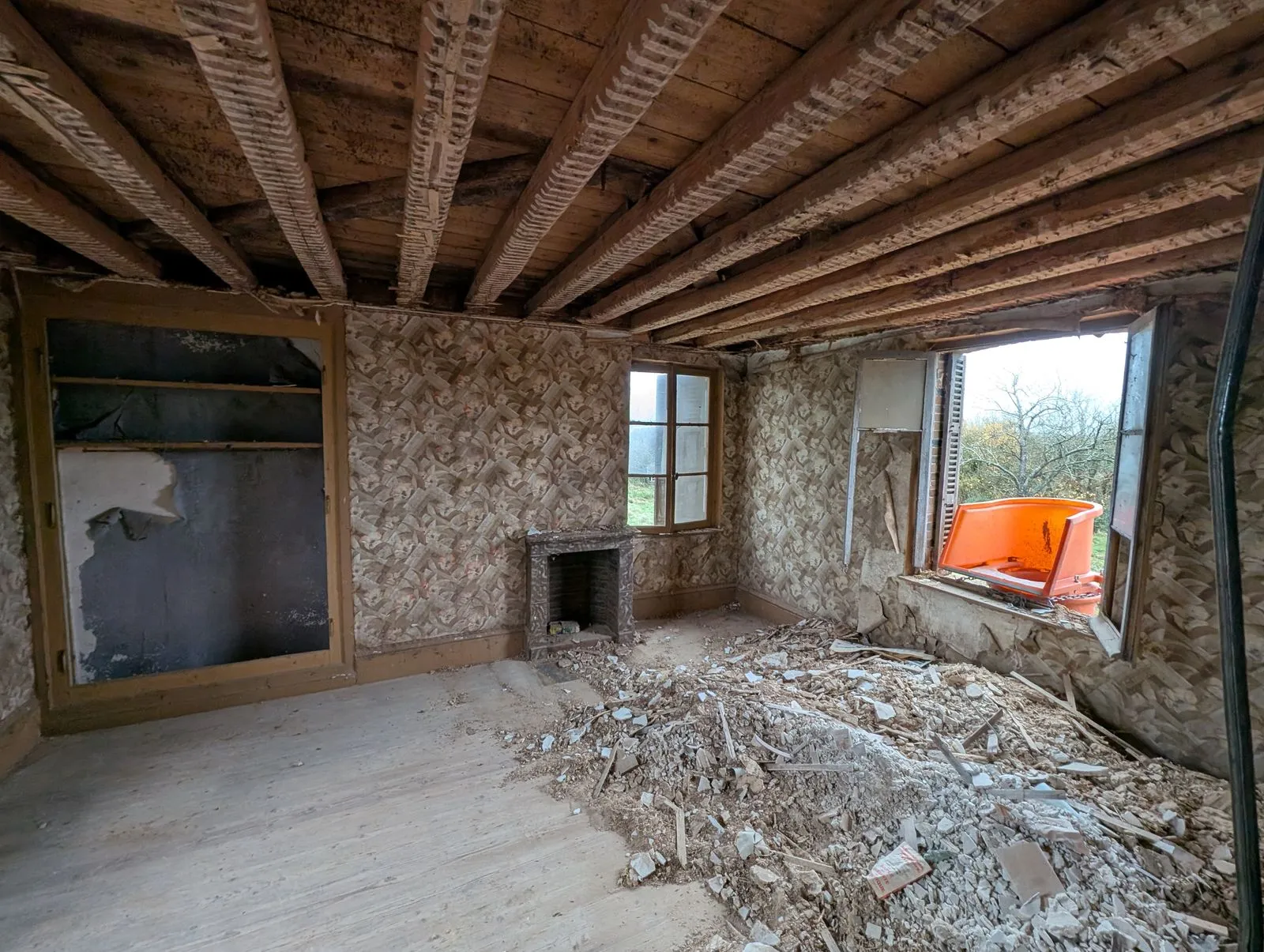 La chambre pendant le chantier : papier peint en cours de dépose, solives mises à nu