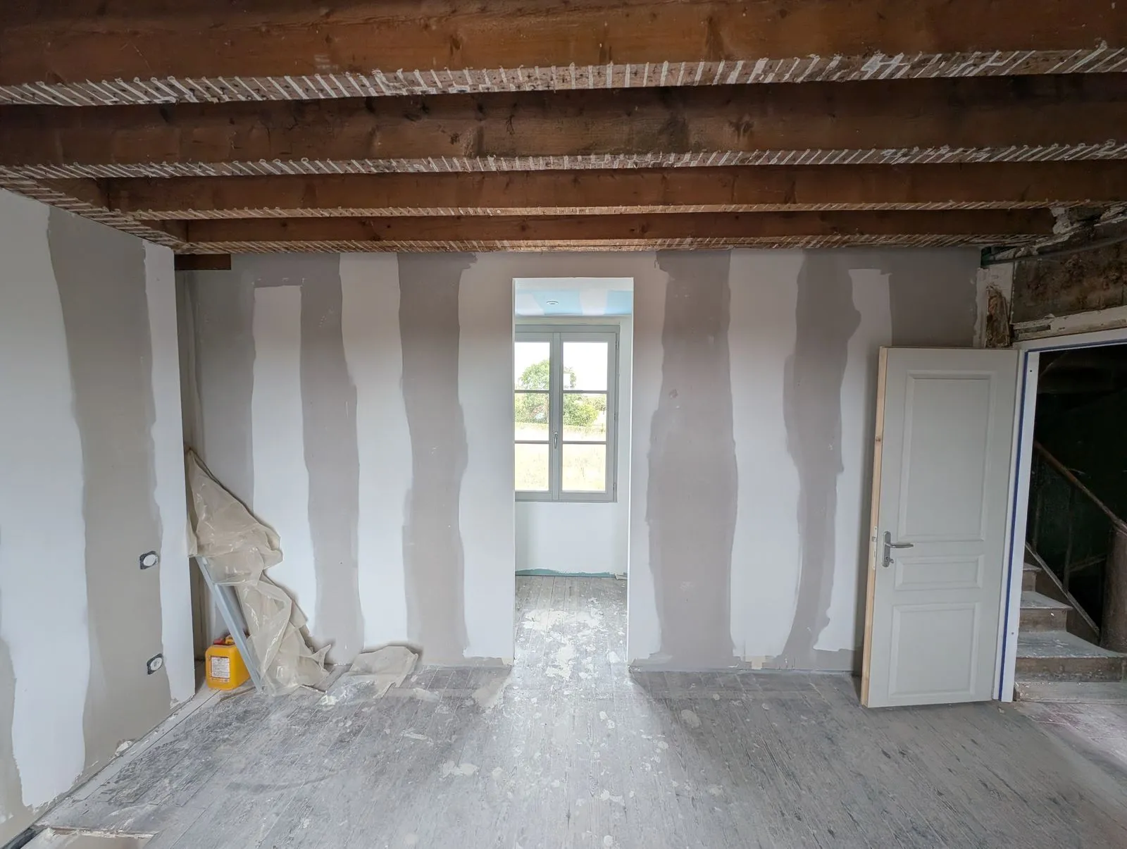 La chambre pendant le chantier : cloisons en plaques de plâtre, solives apparentes